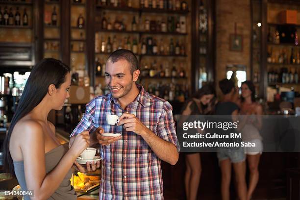 couple having coffee together in cafe - espresso drink stock pictures, royalty-free photos & images