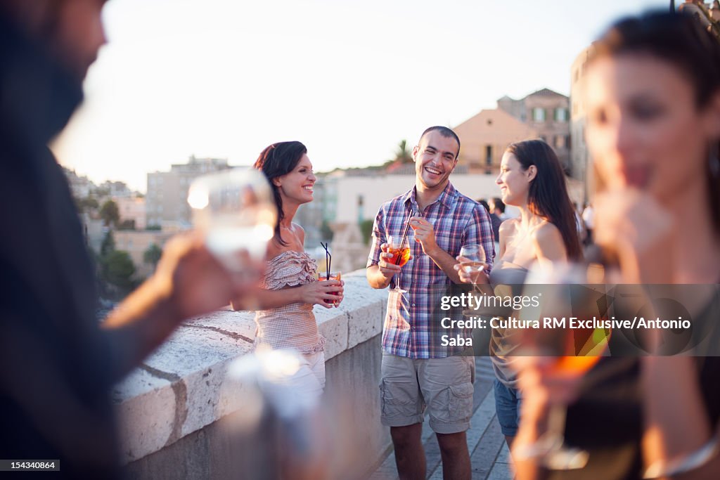 Friends having drinks on balcony