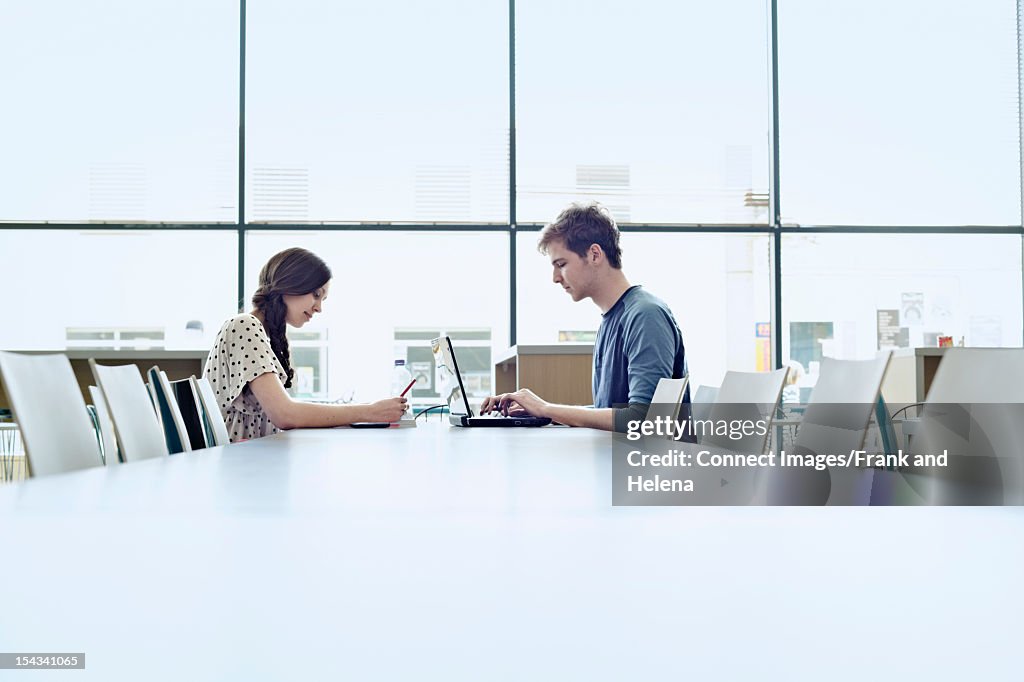 Students studying together in library