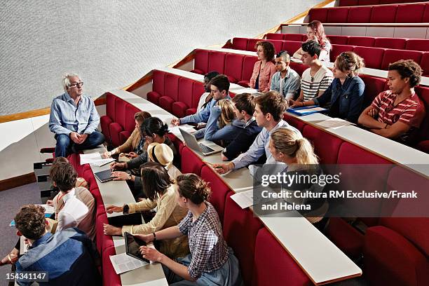students listening to teacher in class - lecture theatre stock-fotos und bilder
