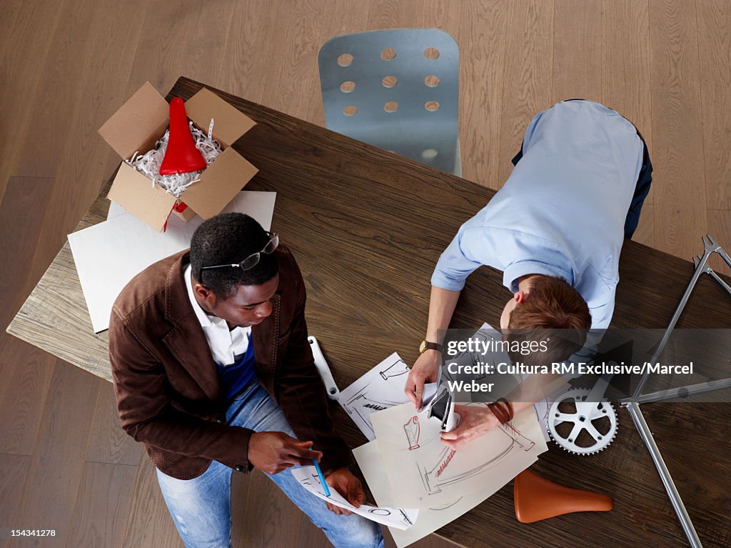 Businessmen designing bicycle parts