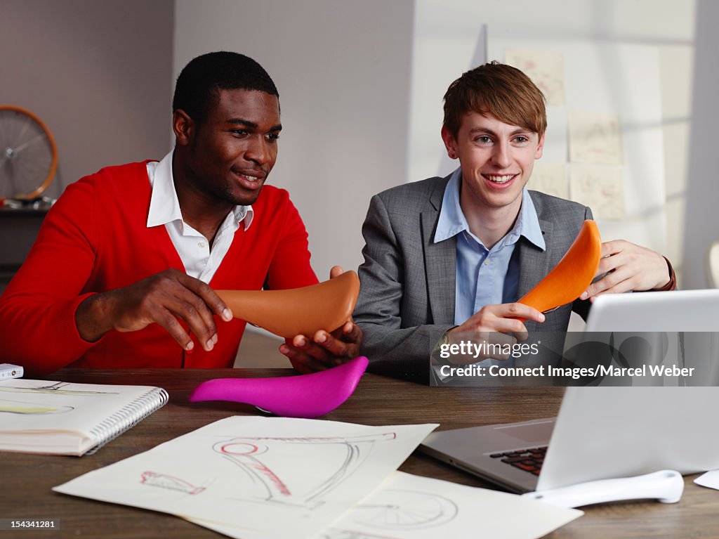 Businessmen examining bicycle seat