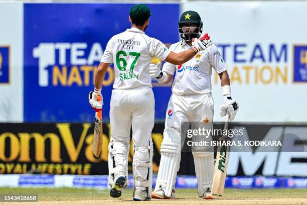 Pakistan's Imam-ul-Haq and Agha Salman celebrate after Pakistan won by 4 wickets on the fifth and final day play of the first cricket Test match...