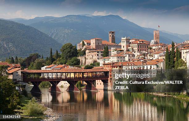 city skyline reflected in still river - bassano del grappa stock pictures, royalty-free photos & images