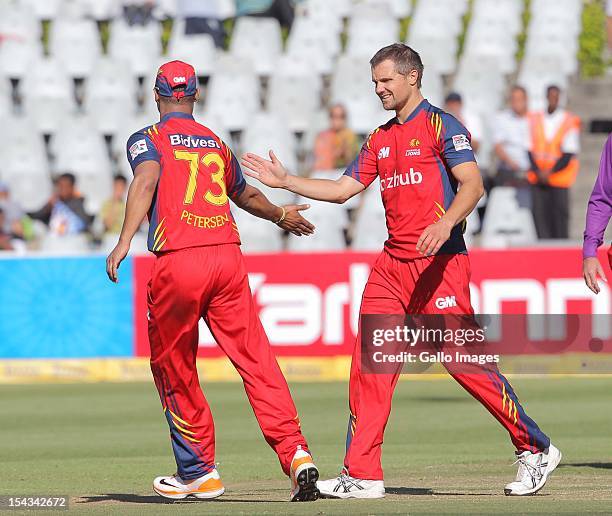 Highveld Lions players celebrate during the Karbonn Smart CLT20 match between bizbub Highveld Lions and Sydney Sixers at Sahara Park Newlands on...