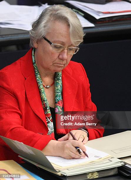 German Federal Education Minister Annette Schavan listens to a government declaration by German Chancellor Angela Merkel in the Bundestag prior to a...
