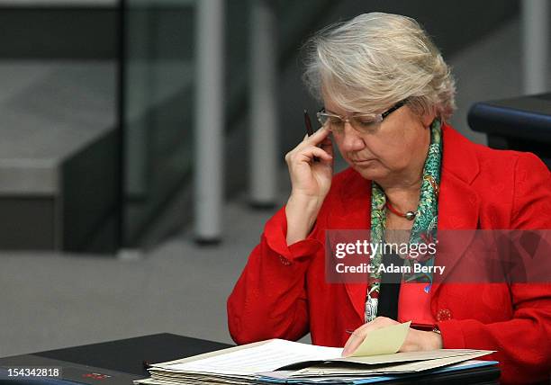 German Federal Education Minister Annette Schavan listens to a government declaration by German Chancellor Angela Merkel in the Bundestag prior to a...