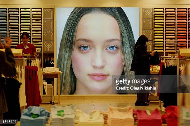 Shoppers looks through clothes at a Benetton store May 17, 2002 in downtown Moscow. U.S. President George W. Bush will visit Russia as part of a trip...