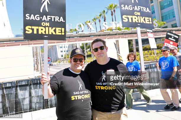 Josh Gad and Rory O'Malley join SAG-AFTRA and WGA members as they walk the picket line on Day 2 outside Fox Studios on July 14, 2023 in Los Angeles,...