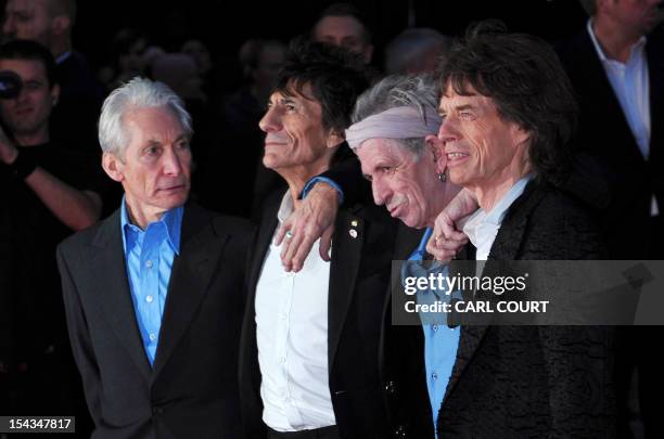 Members of legendary British band The Rolling Stones Charlie Watts, Ronnie Wood, Keith Richards and Mick Jagger pose on the red carpet as they arrive...