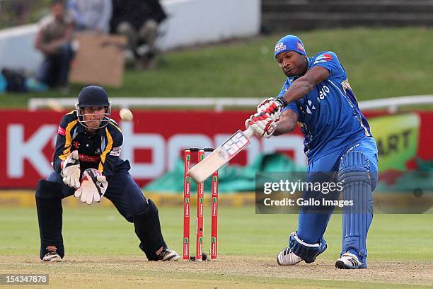 Kieron Pollard of the Mumbai Indians bats as wicketkeeper Dan Hodgson of Yorkshire looks on during the Karbonn Smart CLT20 match between Mumbai...