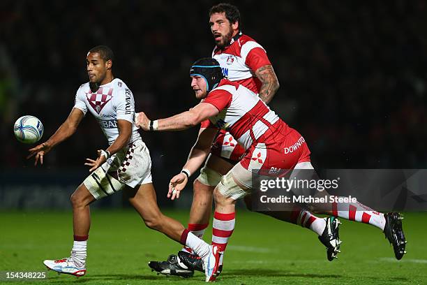 Darly Domvo of Bordeaux-Begles feeds a pass as Ben Morgan and Jim Hamilton of Gloucester close in during the Amlin Challenge Cup match between...