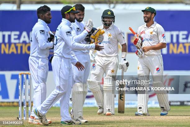 Pakistan's Imam-ul-Haq and Agha Salman walk back to the pavilion after Pakistan won by 4 wickets on the fifth and final day play of the first cricket...