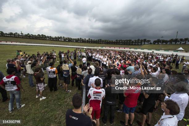 The MotoGP teams and people from the paddock remember Marco Simoncelli on track during the "Tribute for Marco Simoncelli" during the MotoGP Of...