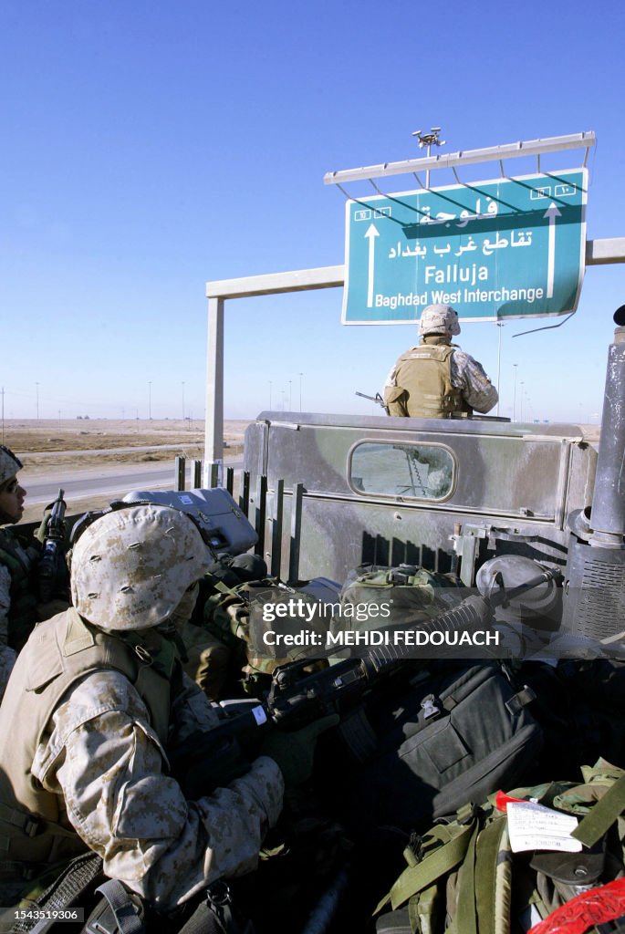 US Marines patrol the highway at the entrance of the restive city of ...