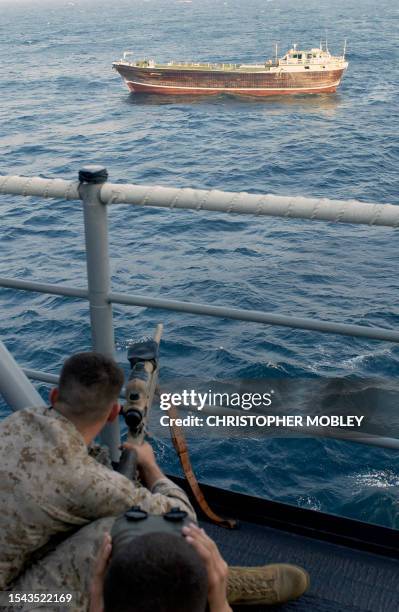 This photo released by the US Navy 04 November shows the Raj Ratan guarded by US Marines from the deck of the USS Port Royal 29 October as it is...