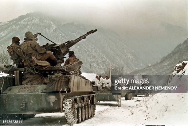 An undated file picture shows Russian soldiers atop an APC taking their position near the village of Shatoy in Chechnya. Military bases are fortified...