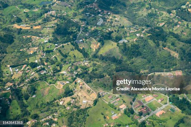 aerial view of rionegro mountains, hills, trees, farms, houses and small facilities in the countryside near medellin, antioquia, colombia - antioquia stock pictures, royalty-free photos & images