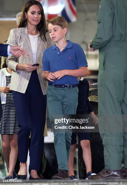 Catherine, Princess of Wales and Prince George of Wales walk down the ramp of a C17 plane during their visit to the Air Tattoo at RAF Fairford on...