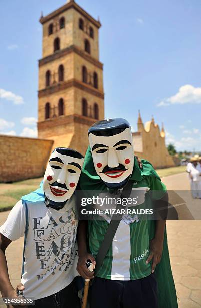Masked residents pose after performing "Los Abuelos" traditional dance for Queen Sofia of Spain in San Jose de Chiquitos, Santa Cruz department,...