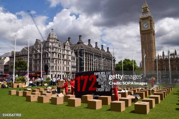 Protesters hold a banner explaining that 172 families are served a Section 21 Eviction Notice every day, during the demonstration. Campaigners from...