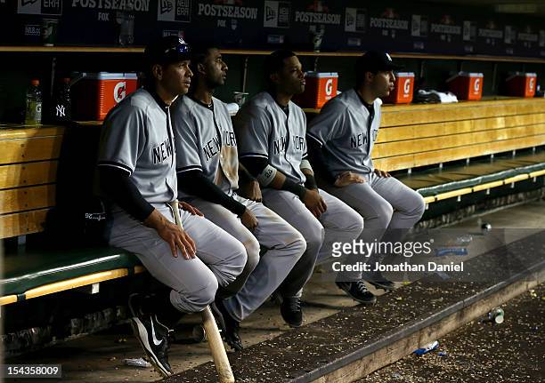 Alex Rodriguez, Eduardo Nunez, Robinson Cano and Mark Teixeira of the New York Yankees look on from the dugout late in the game against the Detroit...
