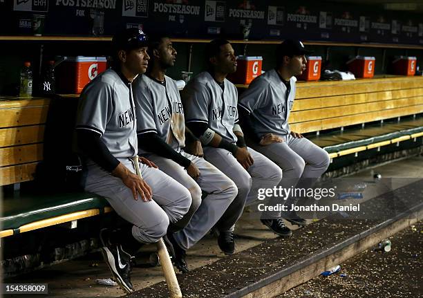 Alex Rodriguez, Eduardo Nunez, Robinson Cano and Mark Teixeira of the New York Yankees look on from the dugout late in the game against the Detroit...