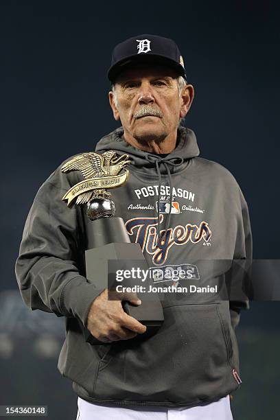 Manager Jim Leyland of the Detroit Tigers holds the American League Championship trophy after they won 8-1 against the New York Yankees during game...