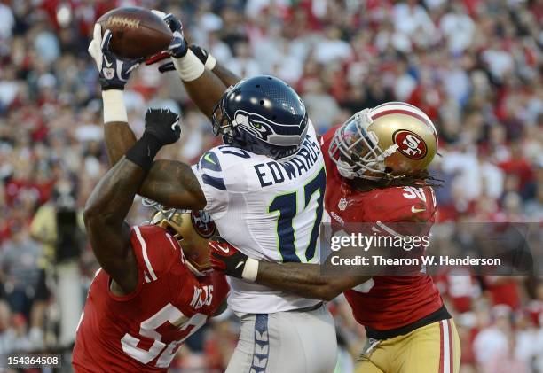 Braylon Edwards of the Seattle Seahawks has this pass broken up in the endzone by Patrick Willis and Dashon Goldson of San Francisco 49ers during the...