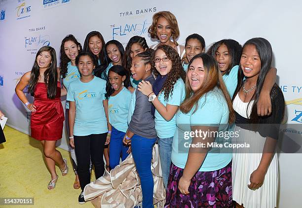 Model/media personality Tyra Banks poses for pictures with girls from the TZONE foundation at The Flawsome Ball For The Tyra Banks TZONE at Capitale...