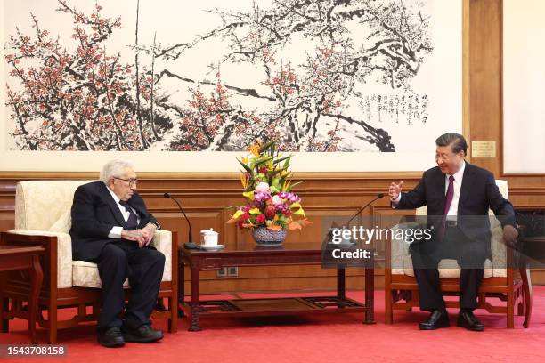 China's President Xi Jinping speaks with former US secretary of state Henry Kissinger during a meeting in Beijing on July 20, 2023. / China OUT