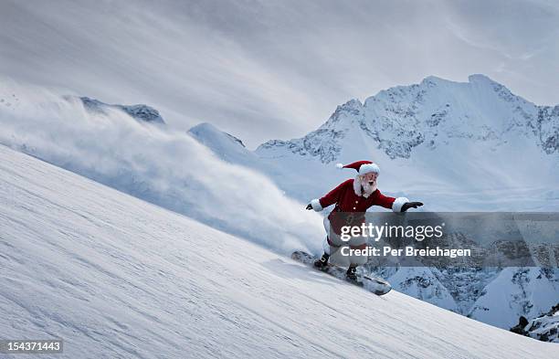 santa claus flying down a mountain on a snowboard - christmas funny stock-fotos und bilder