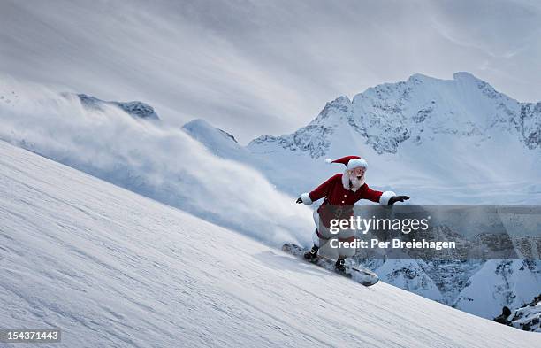 santa claus flying down a mountain on a snowboard - canada christmas stock pictures, royalty-free photos & images