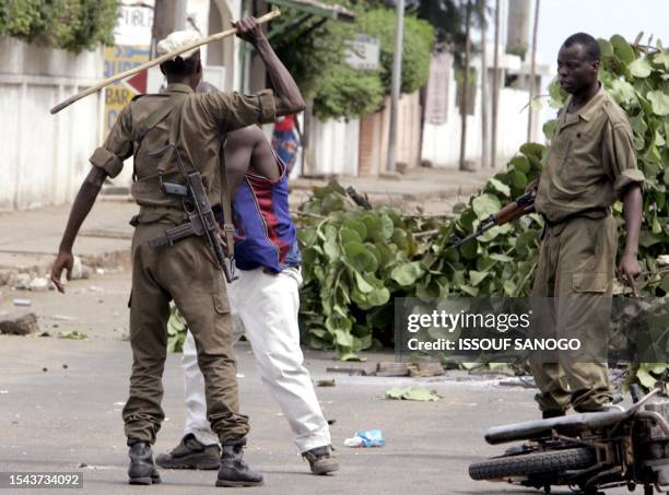 Togolese soldier beats up a man following violent clashes with police forces that erupted after the announcement of the Presidential election results...