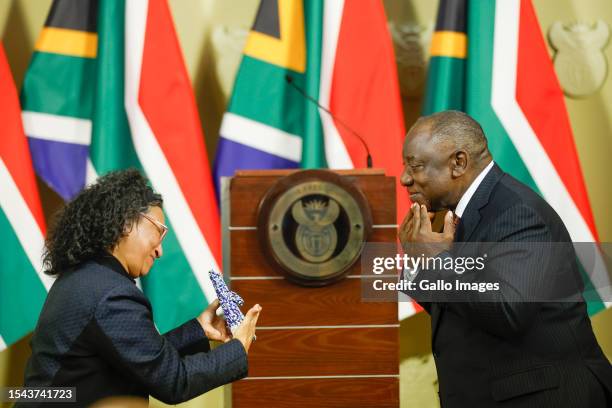 South African President Cyril Ramaphosa and Member of Parliament Dr Wilma Newhoudt-Druchen interact during the signing into law the South African...