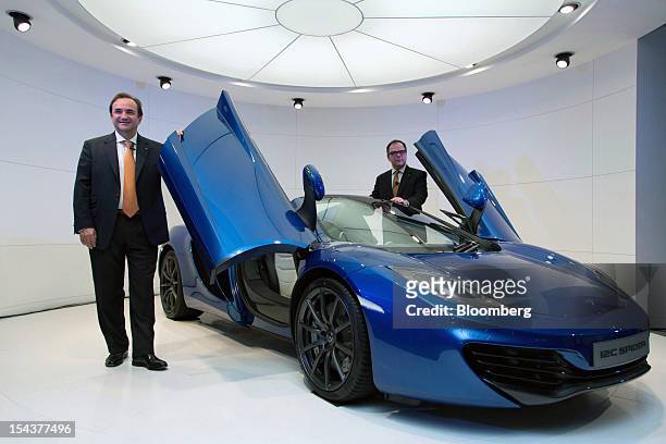 Antony Sheriff, managing director of McLaren Automotive, left, poses with the company's MP4-12C Spider sports car at its launch in Tokyo, Japan, on...