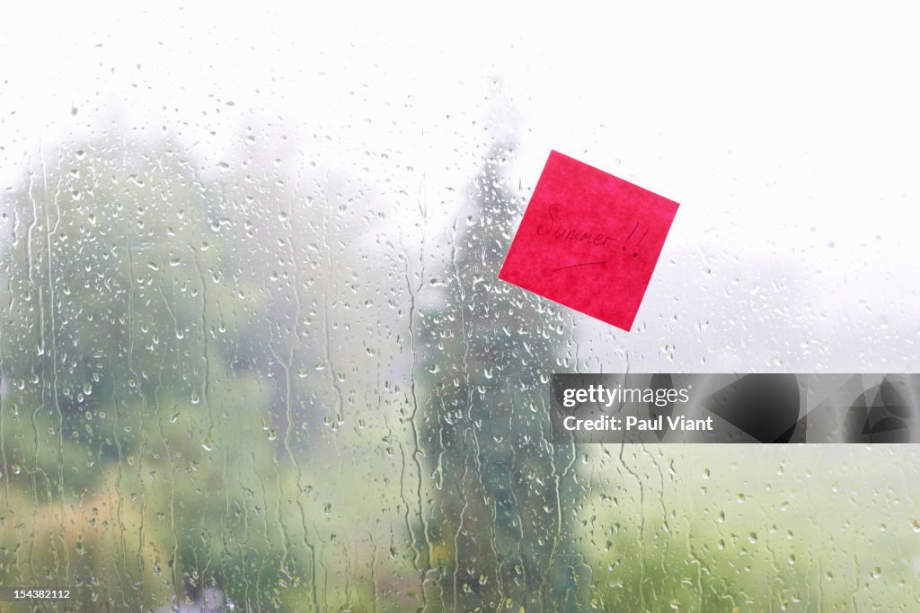 Adhesive note stuck to window summer