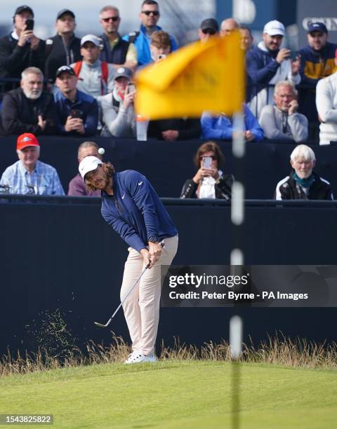 England's Tommy Fleetwood chips onto the first green during day one of The Open at the Royal Liverpool, Wirral. Picture date: Thursday July 20, 2023.