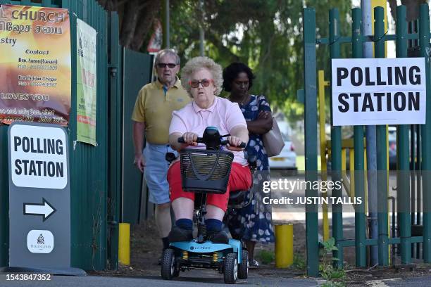 Voters leave the South Ruislip Community Association being used as a polling station during a by-election in the northwest London constituency of...