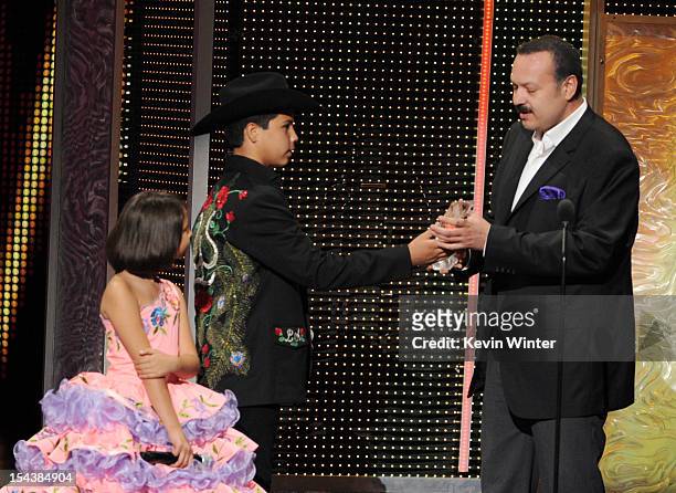 Angela Aguilar and Leonardo Aguilar present the Legado Musical award to their father Pepe Aguilar at the Billboard Mexican Music Awards presented by...