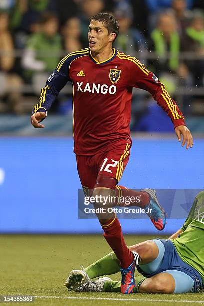 Emiliano Bonfigli of Real Salt Lake dribbles against Jeff Parke of the Seattle Sounders FC at CenturyLink Field on October 17, 2012 in Seattle,...