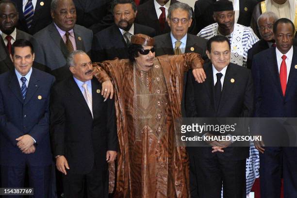 Libyan leader Moammar Gadhafi leans on Egyptian President Hosni Mubarak and Yemeni President Ali Abdullah Saleh as they pose for a group picture with...
