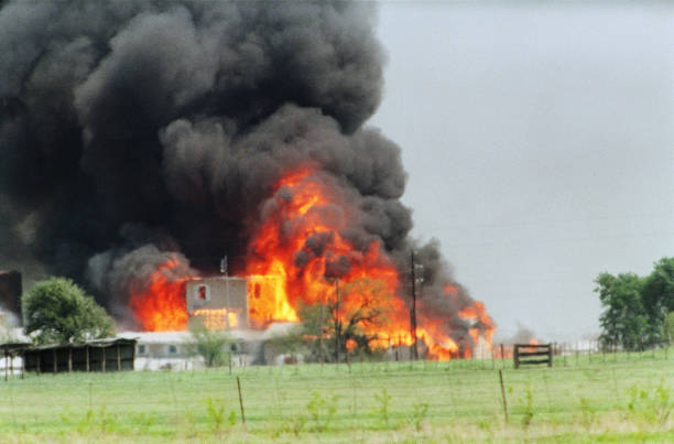 The Branch Davidian cult compound observation tower in Waco, TX is engulfed in flames after a fire burns the complex to the ground 19 April 1993.