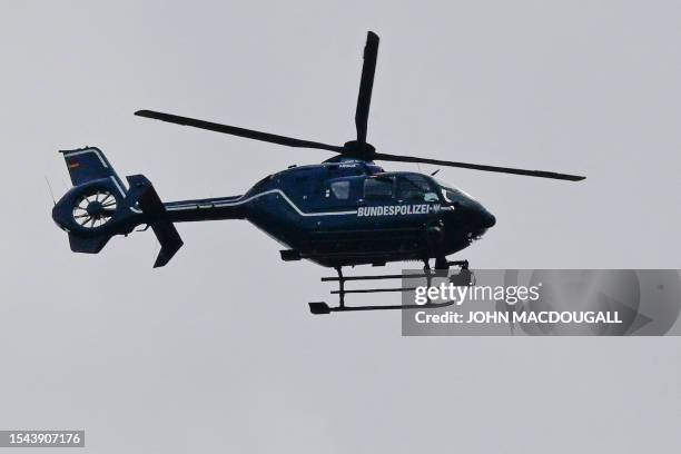 Police helicopter takes part in the search for an a wild animal on the loose, reportedly a lioness in Stahnsdorf, south-west of Berlin on July 20,...