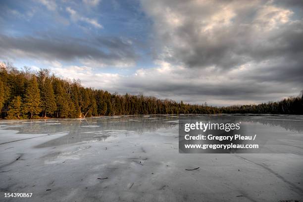 frozen crawford lake during winter thaw - milton ontario stock pictures, royalty-free photos & images