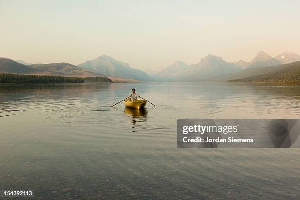 a man in a row boat. - rowboat bildbanksfoton och bilder