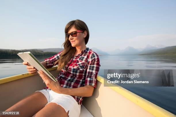 a female using a digital tablet. - lake whitefish stock-fotos und bilder