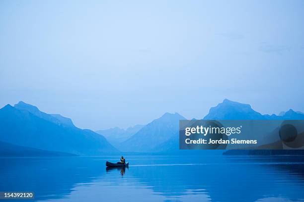 a man in a canoe. - lake whitefish stock-fotos und bilder