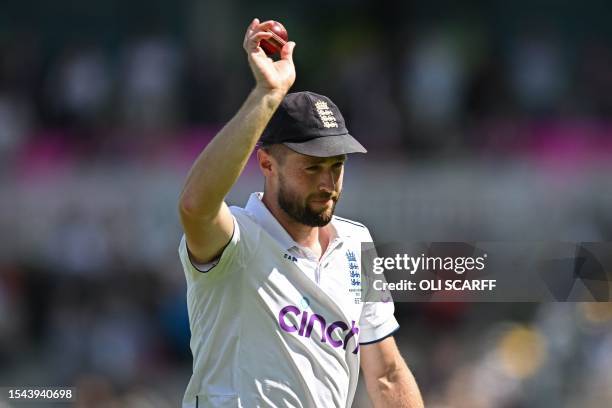 England's Chris Woakes reacts as he leaves the field at the end of the Australian first Innings having taken five wickets, on day two of the fourth...