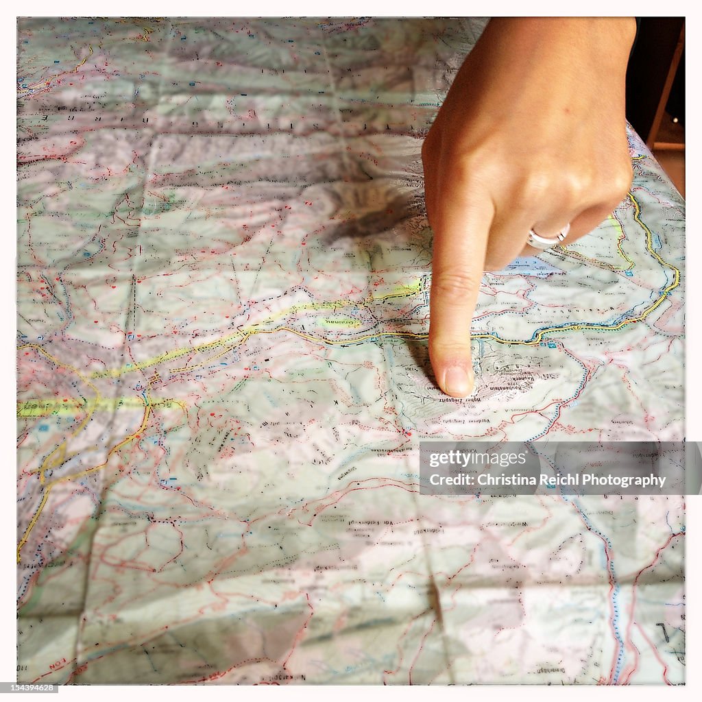 Woman pointing on a map with her index finger